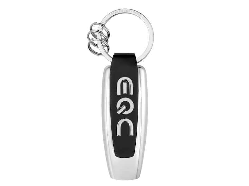 Typo EQC key ring. Silver-coloured/black/blue. Stainless steel/luminous material. Front features replica of original lettering on rear of vehicle, back features 3D star logo. Flat split ring with three additional mini split rings for quick removal/replacement of individual keys. Designed in Germany. Length approx. 9 cm.